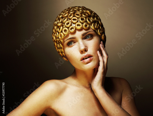 Photo: Creativity. Surreal Stylized Woman with Golden Headwear. Helmet Creativity. Surreal Stylized Woman with Golden Headwear. Helmet