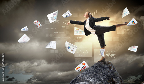 Photo: businesswoman standing atop of mountain businesswoman standing atop of mountain