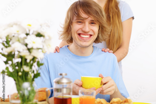 Photo: Young happy man drinking tea Young happy man drinking tea