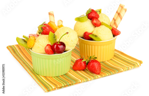 Photo: Delicious ice cream with fruits and berries in bowl isolated Delicious ice cream with fruits and berries in bowl isolated