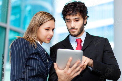 Photo: Two young businesspeople at work Two young businesspeople at work