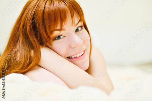 Photo: redhead young woman laying in bed redhead young woman laying in bed