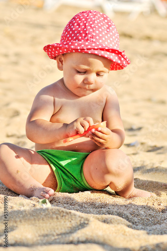 Photo: baby playing on the beach baby playing on the beach