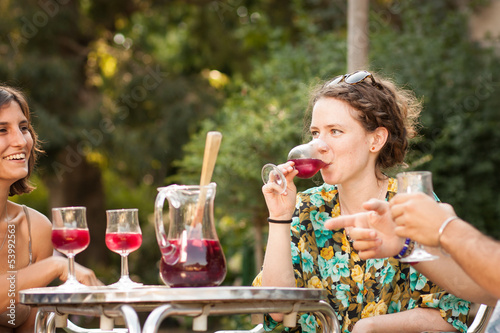Photo: Young woman drinking sangria with friends Young woman drinking sangria with friends