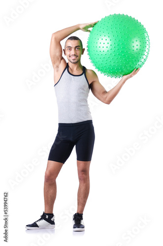 Photo: Man with swiss ball doing exercises on white Man with swiss ball doing exercises on white