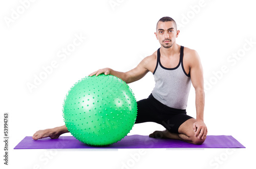 Photo: Man with swiss ball doing exercises on white Man with swiss ball doing exercises on white
