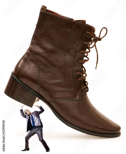 Photo: Woman domination concept with shoes and man Woman domination concept with shoes and man