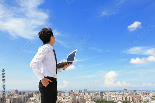 Photo: business man with laptop and look sky and cloud business man with laptop and look sky and cloud