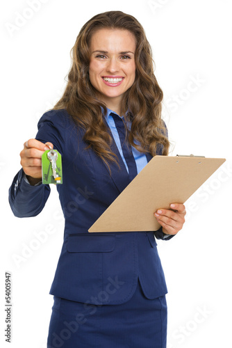 Photo: Smiling realtor woman giving with clipboard keys Smiling realtor woman giving with clipboard keys
