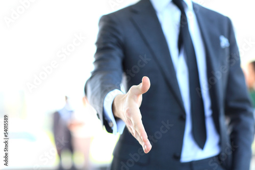 Photo: A business man with an open hand ready to seal a deal A business man with an open hand ready to seal a deal