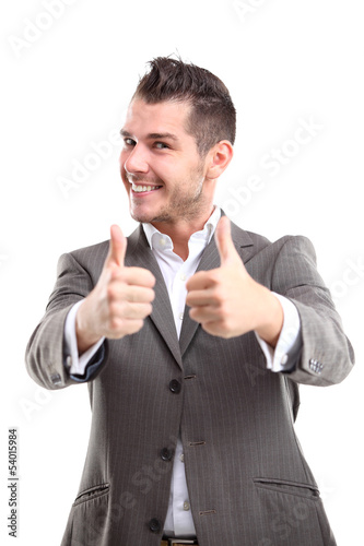 Photo: Happy smiling young business man with thumbs up gesture Happy smiling young business man with thumbs up gesture
