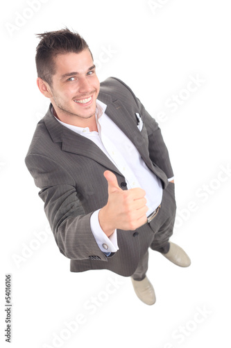 Photo: Happy smiling young business man with thumbs up gesture Happy smiling young business man with thumbs up gesture