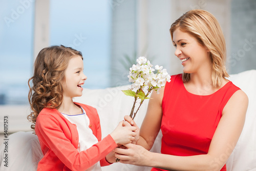 Photo: happy mother and daughter with flowers happy mother and daughter with flowers
