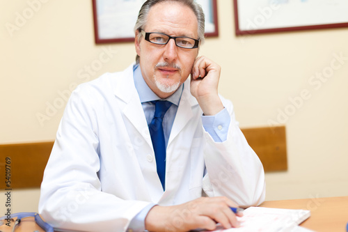 Photo: Doctor sitting in his studio Doctor sitting in his studio