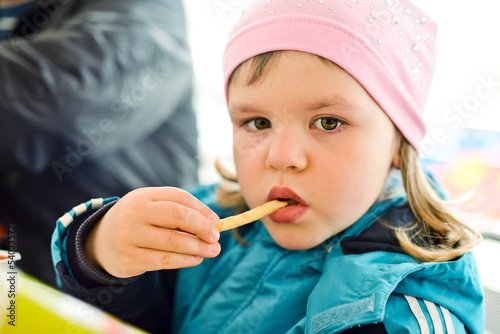 Photo: girl eating french fries girl eating french fries
