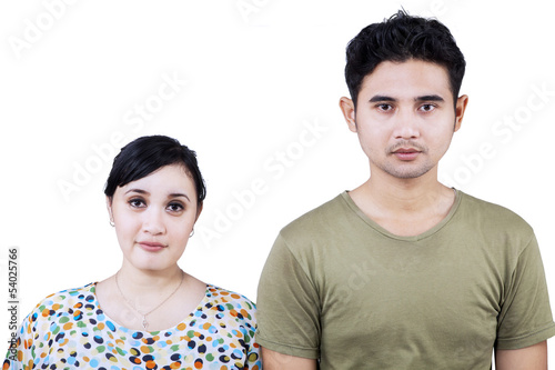 Photo: Asian couple looking at camera - isolated Asian couple looking at camera - isolated