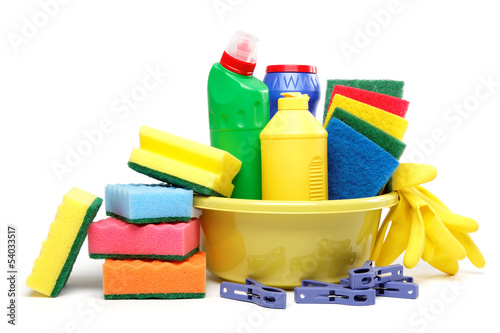 Photo: Detergent bottles, rubber gloves and cleaning sponge on a white Detergent bottles, rubber gloves and cleaning sponge on a white