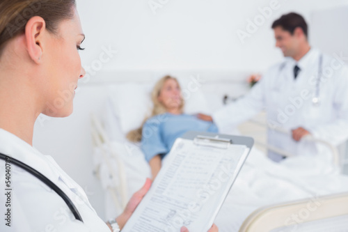 Photo: Doctor reading folder of a patient Doctor reading folder of a patient