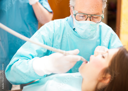 Photo: Dentist drilling a patient Dentist drilling a patient