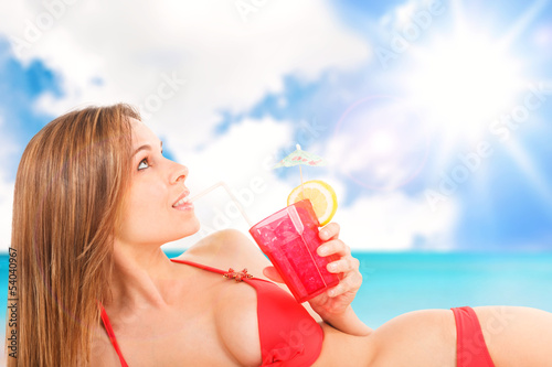 Photo: Woman relaxing on the beach Woman relaxing on the beach