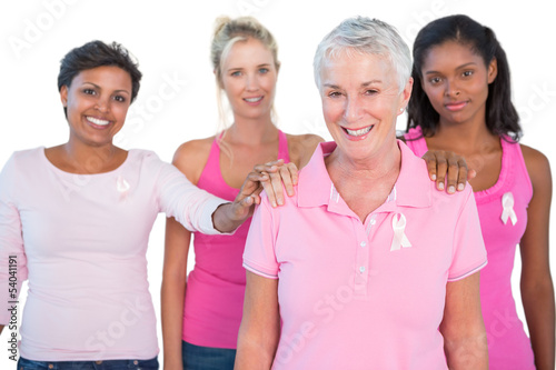 Photo: Supportive group of women wearing pink tops and breast cancer ri Supportive group of women wearing pink tops and breast cancer ri