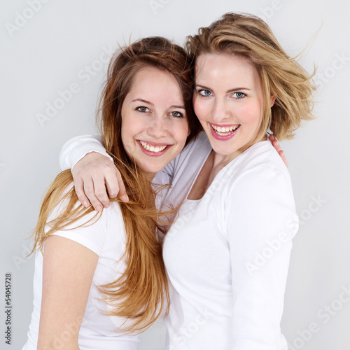 Photo: Two girls are happy at her friendship, hugging each other Two girls are happy at her friendship, hugging each other