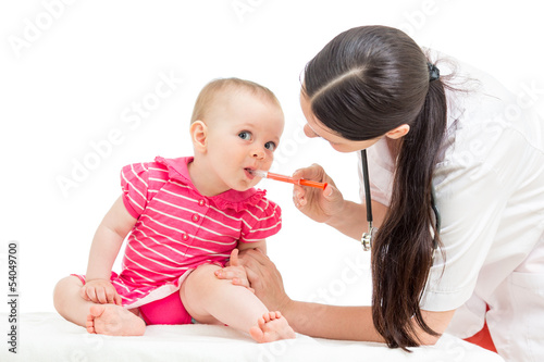 Photo: doctor giving remedy to kid girl isolated on white doctor giving remedy to kid girl isolated on white