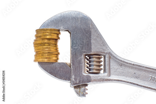 Photo: Golden coins and wrench isolated on white background Golden coins and wrench isolated on white background