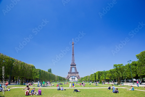 Photo: Eiffel Tower, Paris, France. Tourists and localson Champ de Mars Eiffel Tower, Paris, France. Tourists and localson Champ de Mars