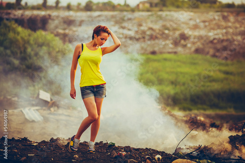 Photo: homeless young beautiful woman in a yellow tank top and denim sh homeless young beautiful woman in a yellow tank top and denim sh