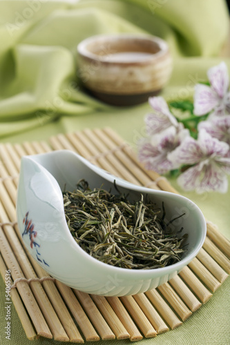 Photo: Loose green tea leaves on bamboo tray Loose green tea leaves on bamboo tray