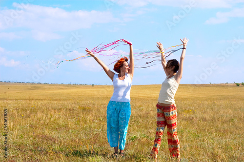 Photo: two young woman with ribbons two young woman with ribbons