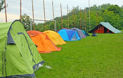 Photo: camp with tents scout campers in a meadow camp with tents scout campers in a meadow