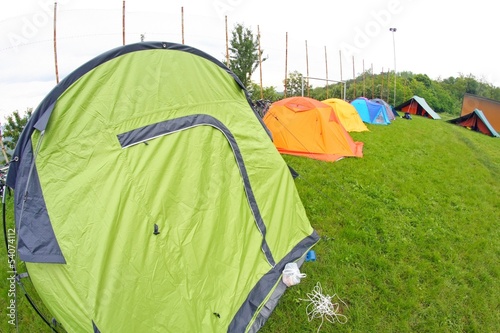 Photo: camp with tents scout campers in a green meadow camp with tents scout campers in a green meadow