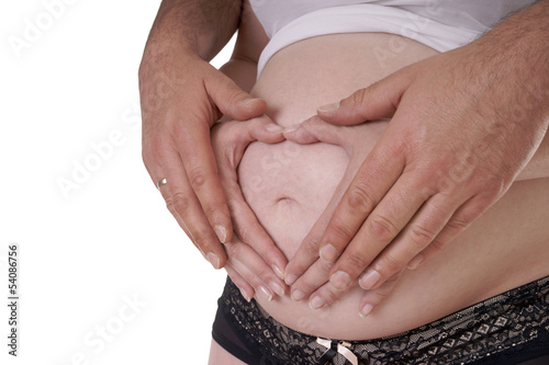 Photo: Männerhände halten den Bauch einer schwangeren Frau Männerhände halten den Bauch einer schwangeren Frau