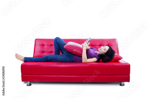 Photo: Young woman reading e-book Young woman reading e-book