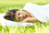 Woman sleeping on grass