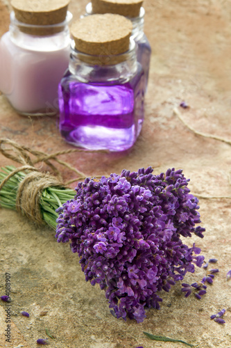 Photo: Bouquet of fresh purple flowers and bottles of soap and lotion Bouquet of fresh purple flowers and bottles of soap and lotion