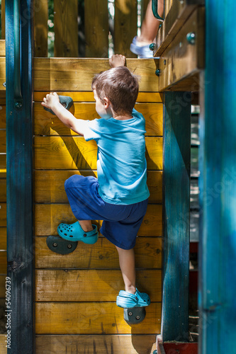 Photo: Little boy climbing on jungle gym Little boy climbing on jungle gym