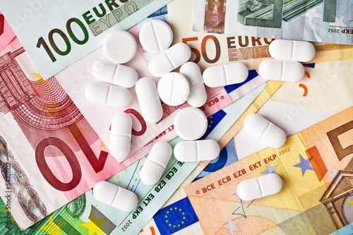Photo: pills and euro banknotes pills and euro banknotes