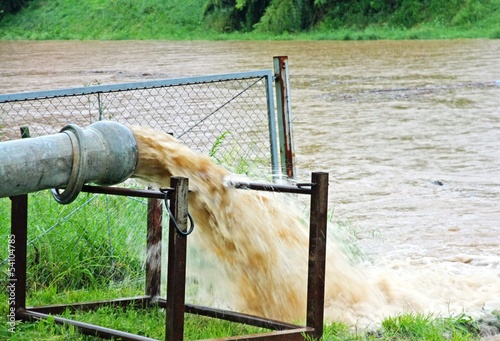 Photo: giant exhaust pipe pours into the muddy and Brown slurry giant exhaust pipe pours into the muddy and Brown slurry