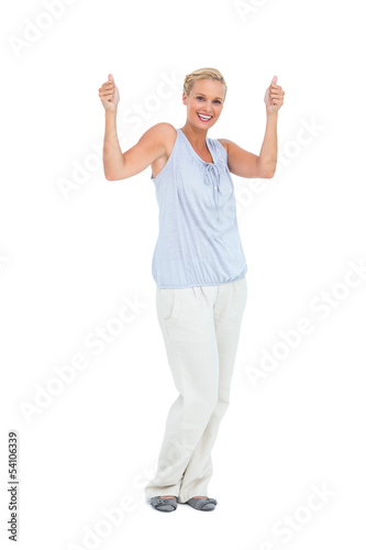 Photo: Blonde woman standing with thumbs up Blonde woman standing with thumbs up