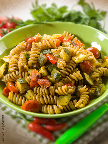 Photo: pasta with zucchinis and tomatoes , selective focus pasta with zucchinis and tomatoes , selective focus