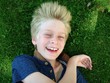 boy lying on grass boy lying on grass