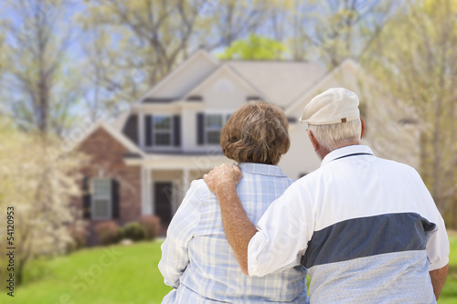 Photo: Retired Senior Couple Looking at Front of House Retired Senior Couple Looking at Front of House