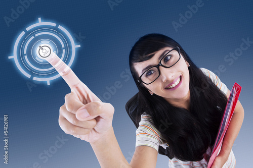Photo: Attractive college student touching virtual screen Attractive college student touching virtual screen