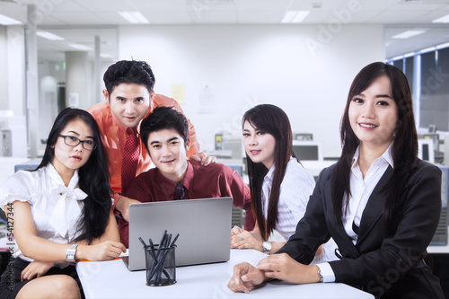 Photo: Business manager and team in office Business manager and team in office