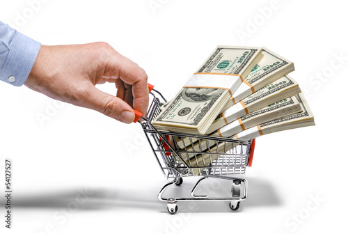 Photo: businessman's hand & steel grocery cart full of money stacks businessman's hand & steel grocery cart full of money stacks