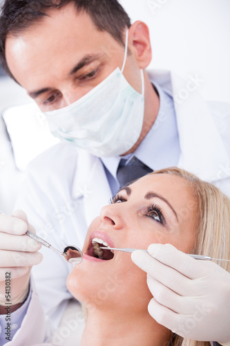 Photo: Dentist Examining Patient Dentist Examining Patient