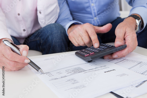 Photo: Close-up of couple doing finances at home Close-up of couple doing finances at home